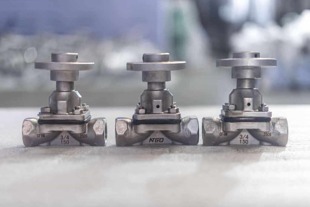 Stainless steel diaphragm valve product photo showing small-size industrial diaphragm valves in a real manufacturing setting