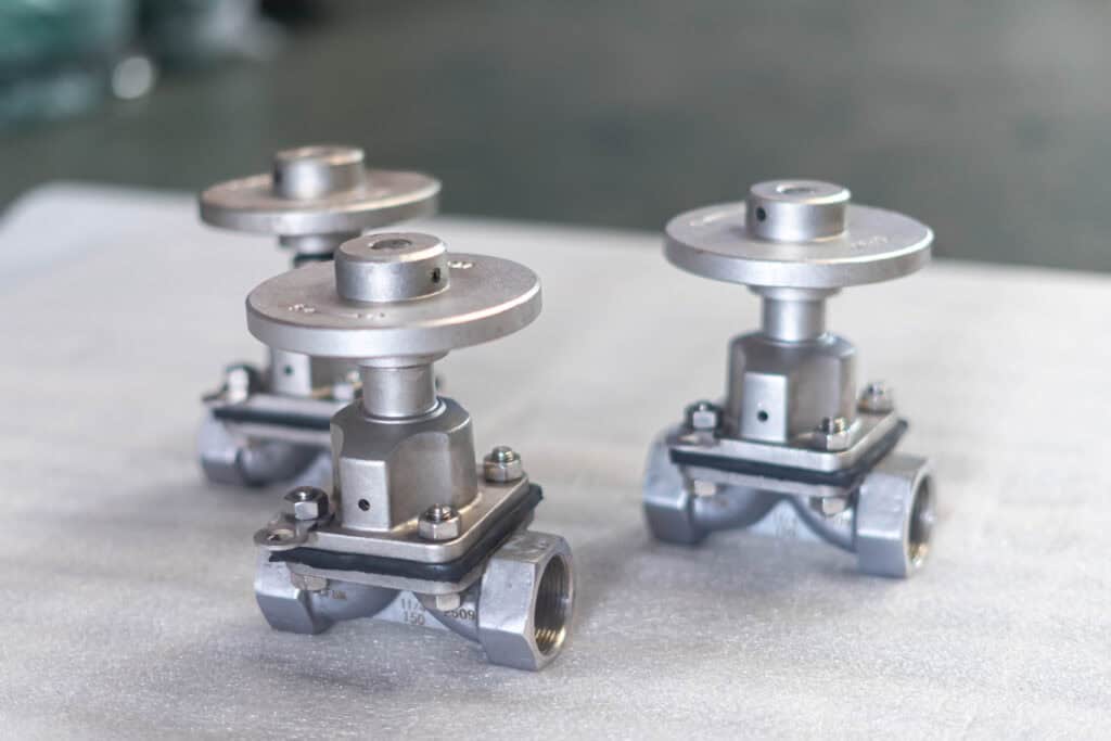 Small stainless steel diaphragm valve product photo in a manufacturing setting
